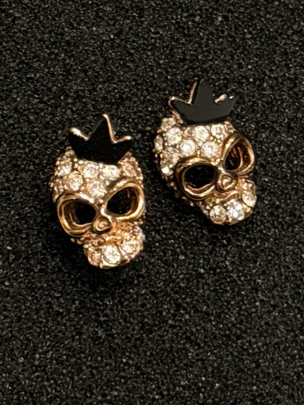 Gold tone crystal skull earrings